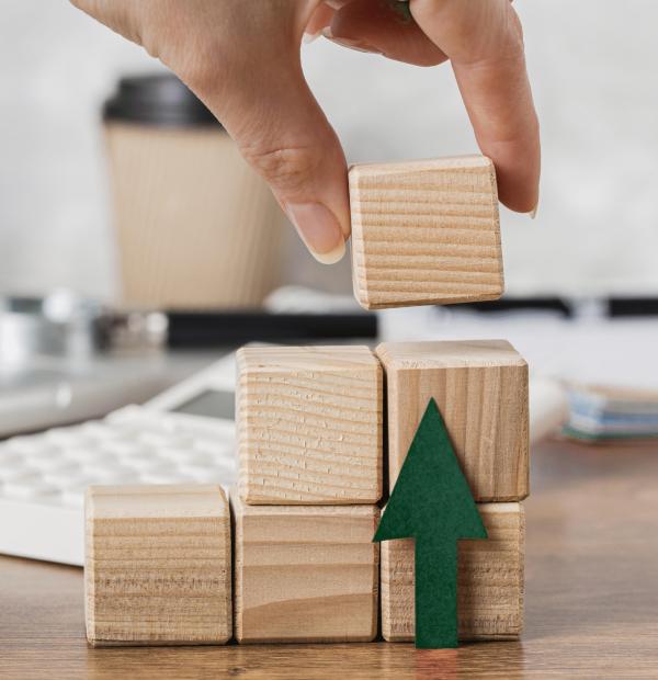 hand-placing-wooden-block-represent-growth